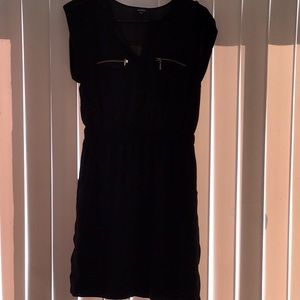 Black dress with gold zipper pockets in front